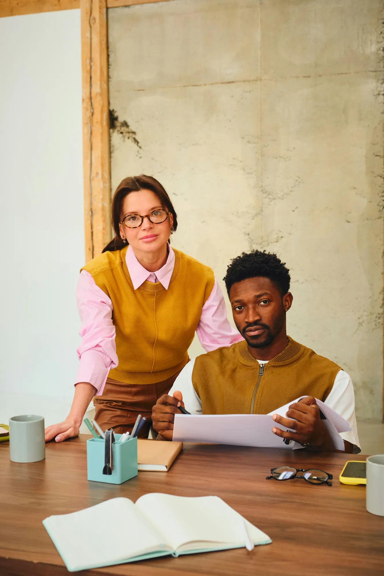 Two preparers at a desk reviewing a client's documents